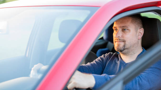 istock Mid adult man driving his car 1159473726