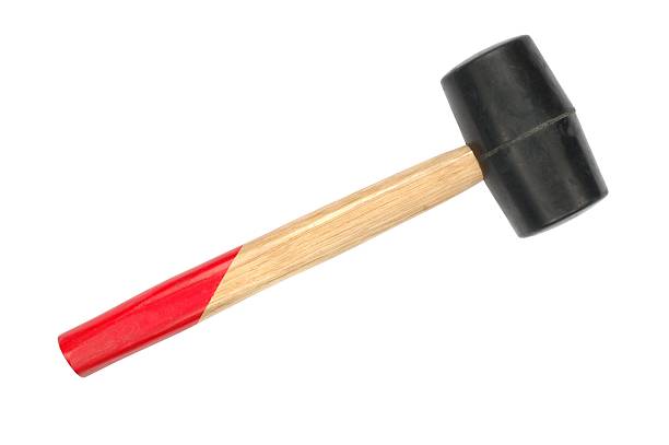 istock Wooden mallet with a partly red handle and black head 115947488