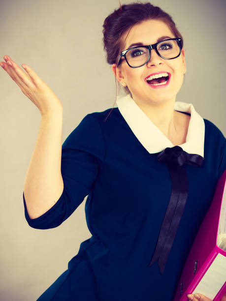 istock Happy positive business woman holding binder with documents 1159476086