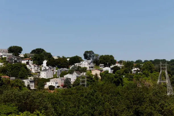 Lower Merion Township, PA, USA - July 1, 2019: A cascade of homes make up the skyline of suburban enclave Belmont Hills in Montgomery County, Pennsylvania.