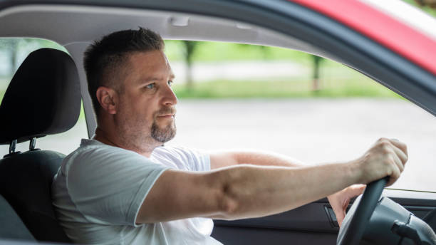 istock Mid adult man driving his car 1159477208