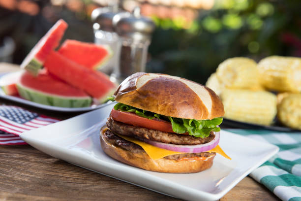 picnic con hamburger con anguria e mais - picnic watermelon summer food foto e immagini stock