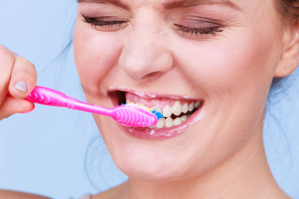 istock Woman brushing cleaning teeth 1159480269