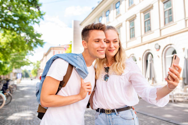 istock Young couple taking a selfie in a city 1159480387