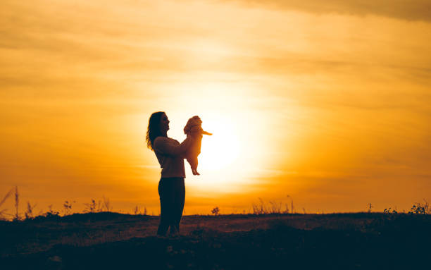 istock Holding her dog against sunlight 1159480598