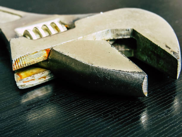 istock Close up of wrench in wood surface 1159480650