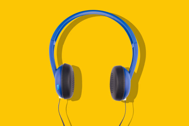 istock blue headphones isolated on yellow background 1159483022