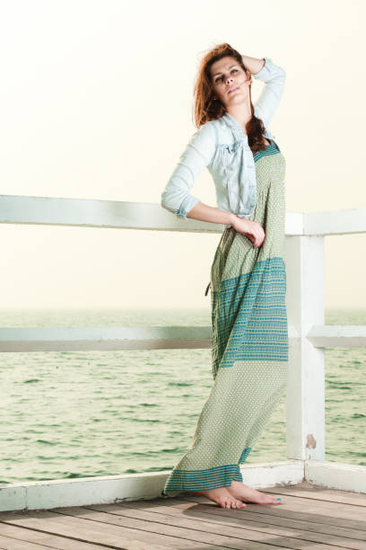 istock Young woman relaxing on pier outdoor 1159483049