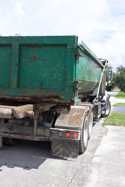 istock picking up full roll-off dumpster at residential  construction site for efficient disposal 1159483051