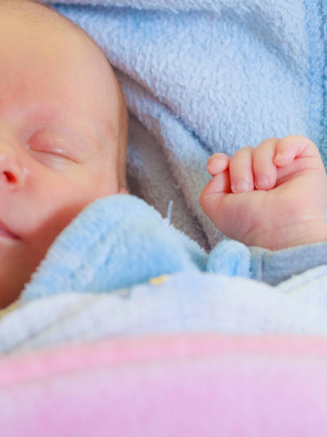 istock Little newborn baby sleeping calmly in blanket 1159483170