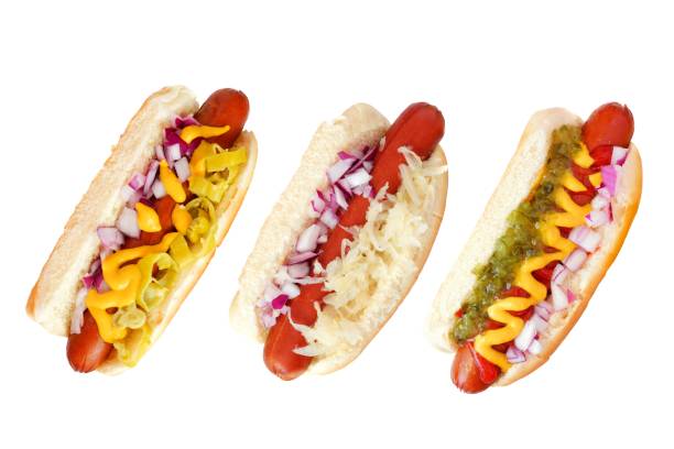 Three hot dogs with an assortment of toppings, top view isolated on white Three hot dogs with an assortment of toppings, top view isolated on a white background relish stock pictures, royalty-free photos & images