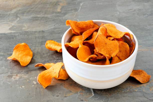 istock Healthy sweet potato chips over a slate background 1159484242