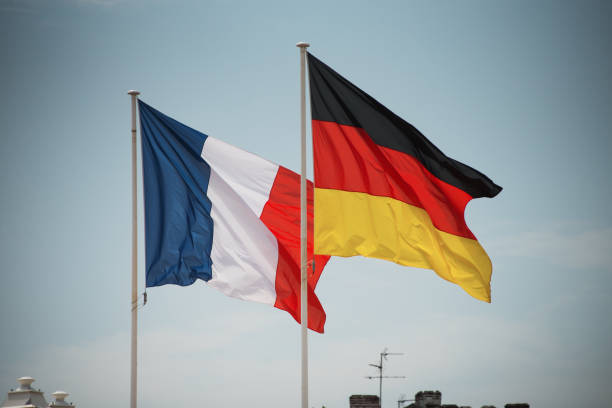 French and German flags waving together A french and a german flag waving together german flag photos stock pictures, royalty-free photos & images