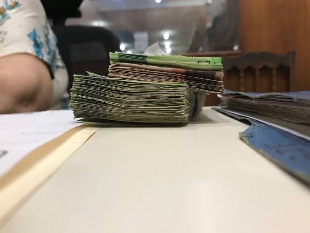 istock Many mexican peso money bills stacked on a beige coloured table 1159485917