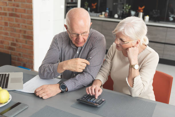 istock Senior couple paying bills together on laptop 1159485982