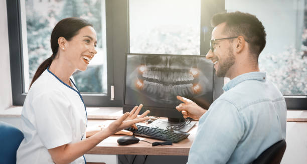 istock Dentist and patient consultation with x-ray image 1159485995