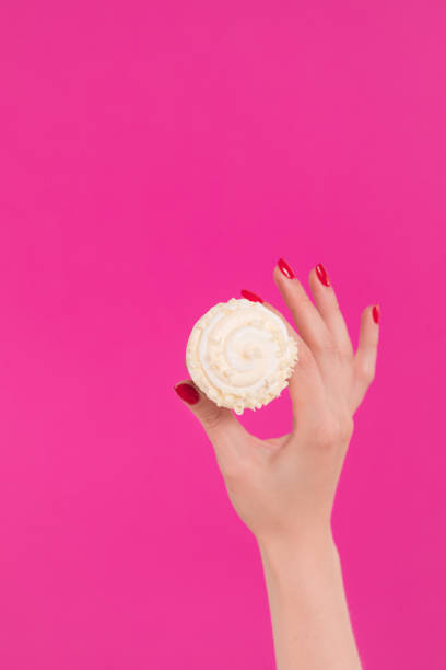 istock Female hand holding ice cream in waffle cone 1159488368
