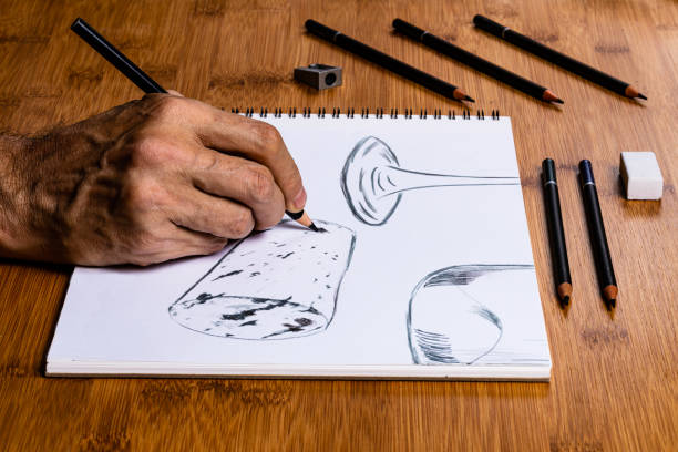 istock An Artist Sketching a wine bottle, wine glass and a cork at a work table in their studio using pencils and charcoals. 1159494276