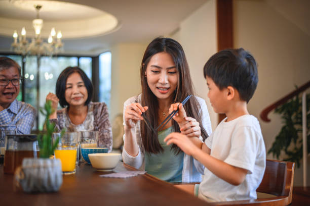 istock Taiwanese Mother and Son Playing With Chopsticks 1159495265
