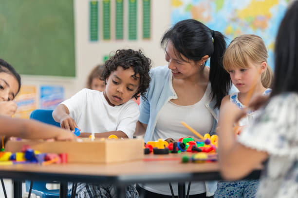 istock Young Asian Teacher Helps Her Male Student 1159495520