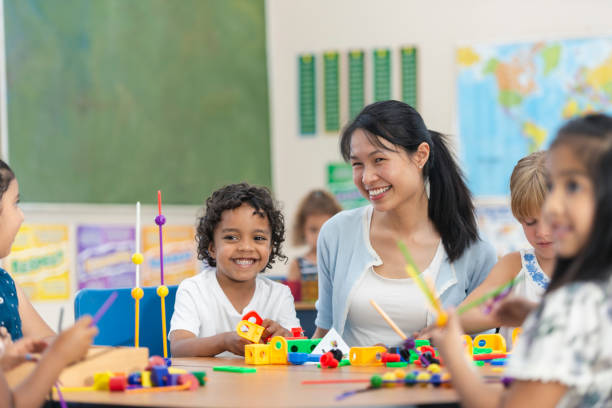 istock Young Asian Teacher Helps Her Male Student 1159495522