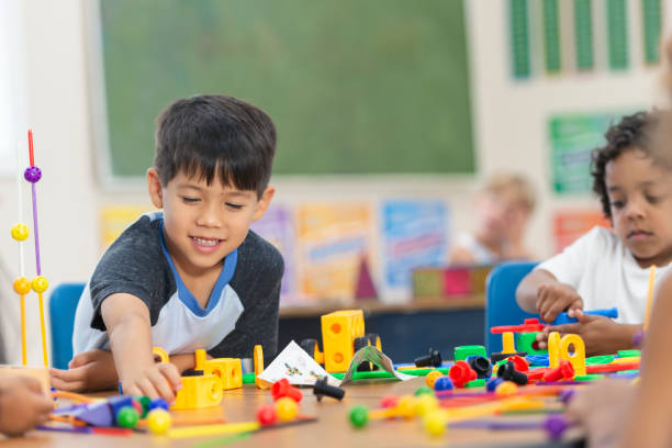 istock Adorable Little Kindergarten Boy Doing an In-Class Activity 1159495531