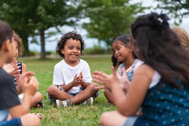 istock A Multi-Ethnic Group of Young Children are Clapping Outside 1159495564