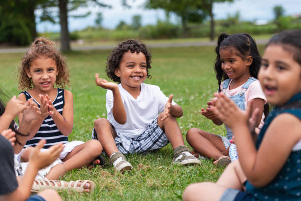 istock A Multi-Ethnic Group of Young Children are Clapping Outside 1159495565