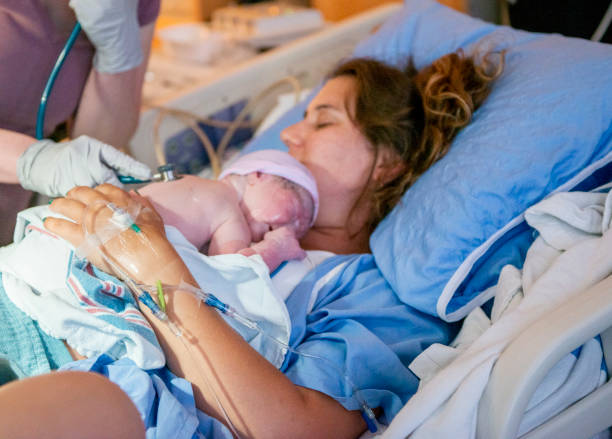 istock Young mother with her newborn baby 1159500445