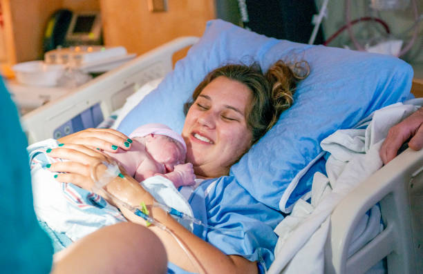 istock Young mother with her newborn baby 1159500447