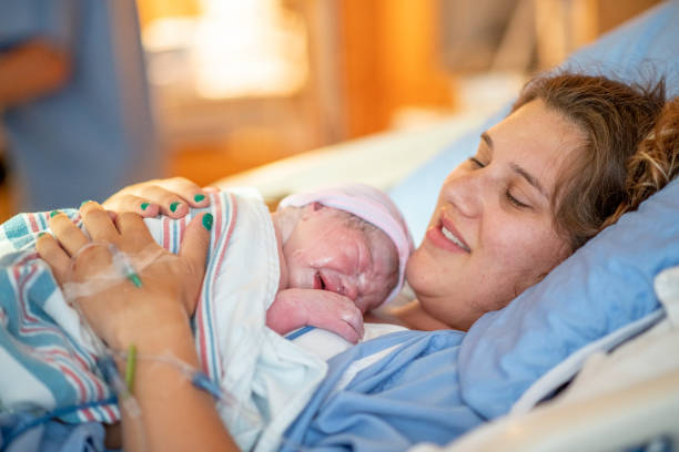 istock Young mother with her newborn baby 1159500451