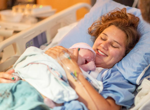 istock Young mother with her newborn baby 1159500455