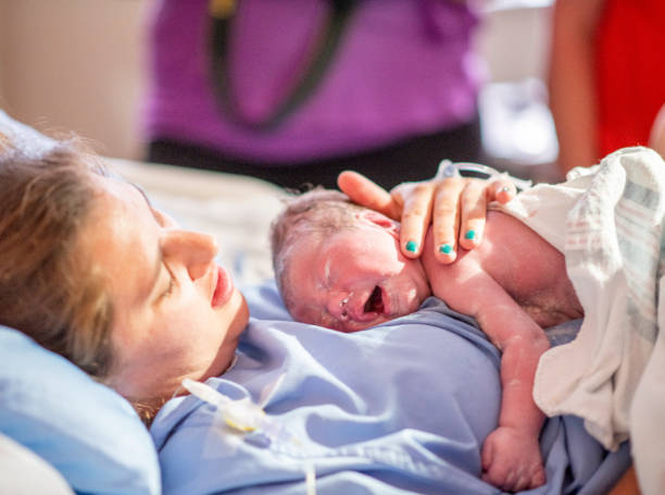 istock Young mother with her newborn baby 1159500457