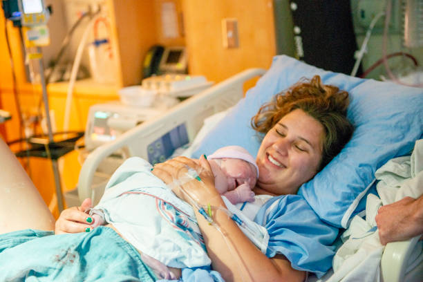 istock Young mother with her newborn baby 1159500459