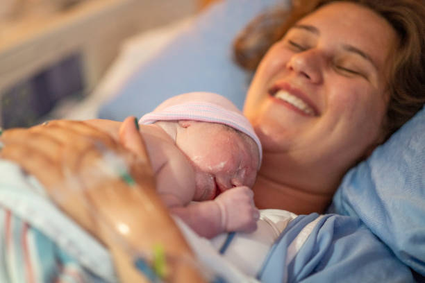 istock Young mother with her newborn baby 1159500461