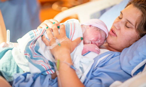 istock Young mother with her newborn baby 1159500462