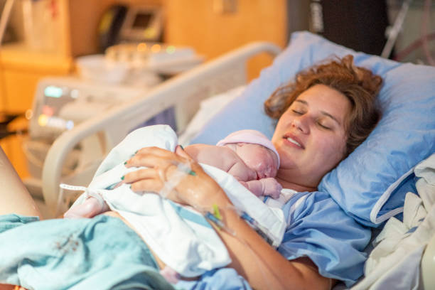 istock Young mother with her newborn baby 1159500464