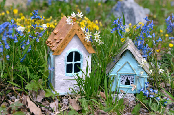istock Two tiny fairy houses in spring flowers 1159501061