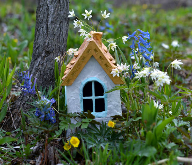 Tiny adorable fairy house under the tree in the garden.