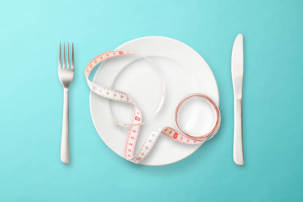Place setting with measuring tape on light blue background