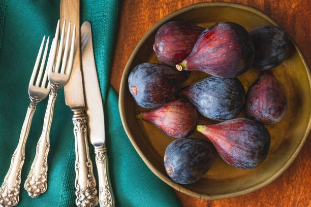 istock Figs Close Up on a Wooden Kitchen Table, View from Above 1159506188