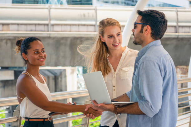 istock business people or university students having hands shake outdoor 1159508257
