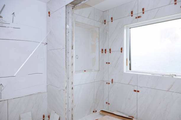 istock Spreading wet mortar before applying tiles on bathroom tile. 1159510023
