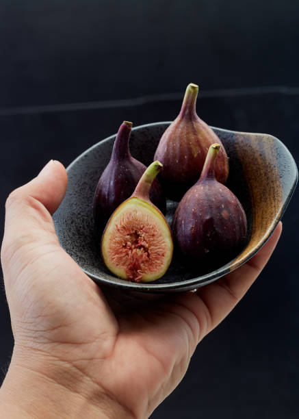 istock Holding plate with cut ripe figs organic food 1159514313