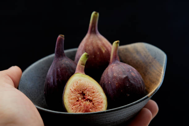 istock Holding plate with cut ripe figs organic food 1159514360