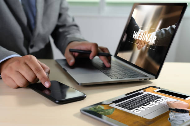 istock WEBINAR man hand on table Business, coffee, Split tone WEBINAR phone 1159514489