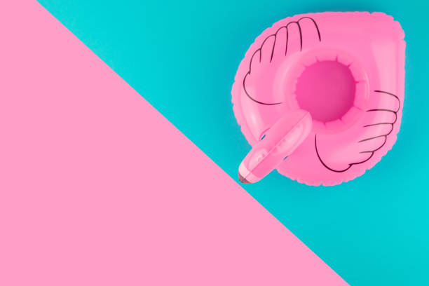 istock Inflatable pink flamingo on pastel blue and pink background. Summer beach composition. Flat lay, top view, copy space. 1159517232