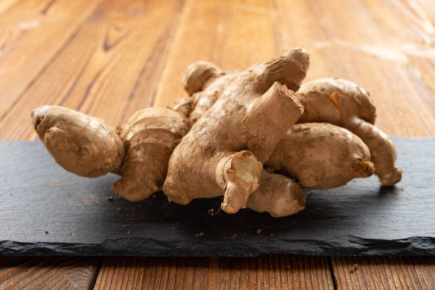 istock piece of ginger on a wooden table 1159518766