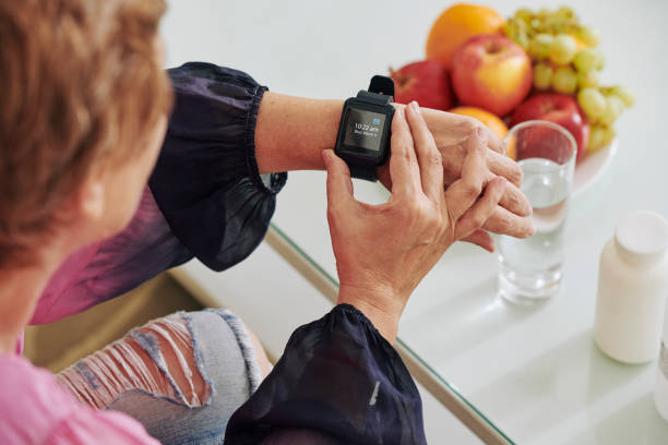 istock Senior woman checking smartwatch 1159518808