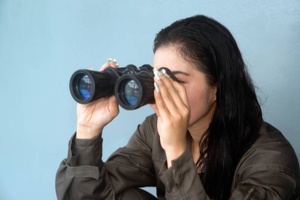 istock Pretty Asian female soldier looking with Binoculars on a ship. 1159519161